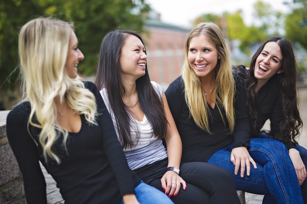 Friends Enjoying Life and Women’s Wellness Support – obgyn miami Group of smiling women sitting outdoors, representing friendship, confidence, and comprehensive women’s health and OB-GYN care – obgyn miami
