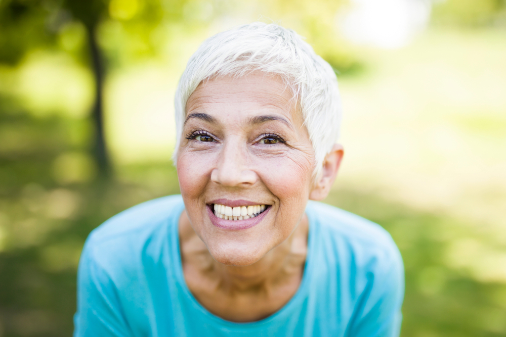 Advanced Gynecology Exam Equipment and Patient Consultation – obgyn miami Portrait of a smiling sporty senior woman in a park at summer day