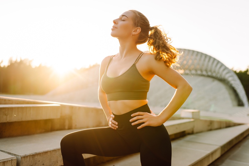 Active Woman Embracing Strength and Wellness Outdoors – obgyn miami Healthy, confident woman exercising outdoors at sunrise, symbolizing vitality, balance, and comprehensive women’s health care – obgyn miami