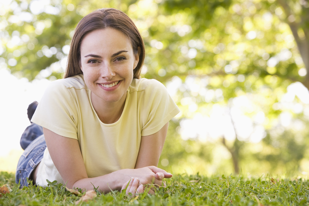 Woman relaxing in park smiling